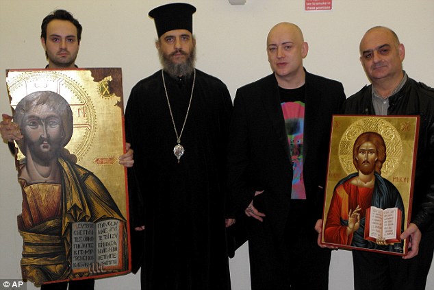 Gilt-edged occasion: Boy George and composer John Themis with the token of gratitude given them by the Church of Cyprus after the return of the icon, held by an unnamed official with Bishop Porfyrios